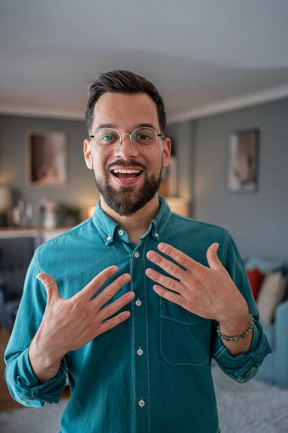 istock Young businessman making a video call from home, looking surprised and happy 2234556500