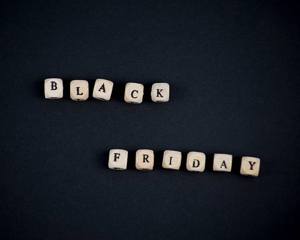 istock Black Friday spelled with wooden blocks on black background top view 2234561225