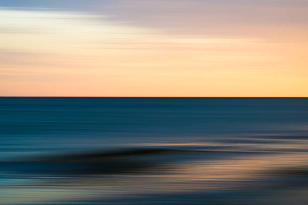 istock Sunset glow over blurred sea waves 2234561419