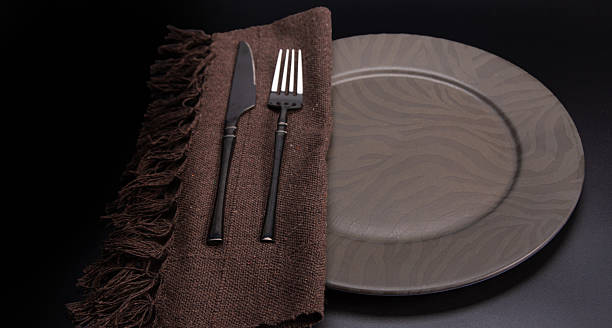 istock Beautiful table setting, beautiful plate, cutlery and napkin placed on a dark background, selective focus. 2234562001