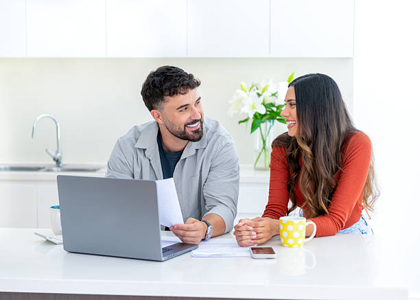 istock Young couple doing paperwork  and finances at home in the kitchen. 2234565154