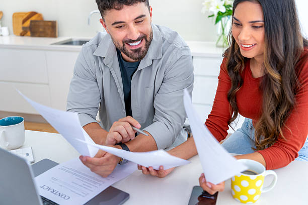istock Young couple doing paperwork  and finances at home in the kitchen 2234565172