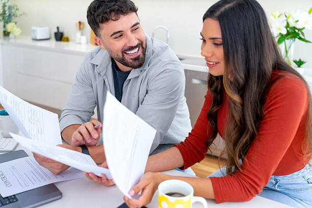 istock Young couple doing paperwork  and finances at home in the kitchen. 2234565200