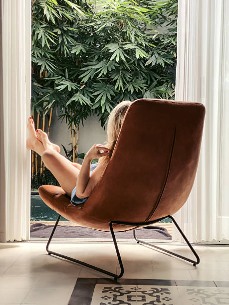 istock Woman sunbathing in a chair 2234565404