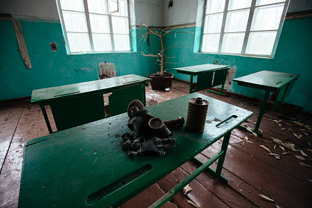 istock Old gas mask on desk in abandoned school 2234570599