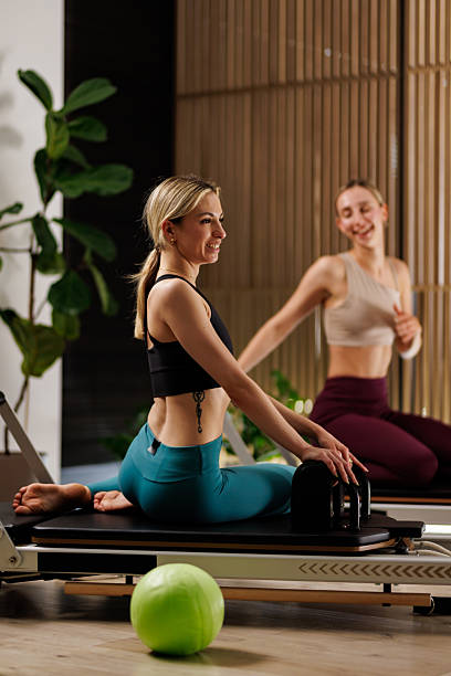 istock Two women practicing Pilates in a modern studio with plants and equipment during a wellness session 2234572138
