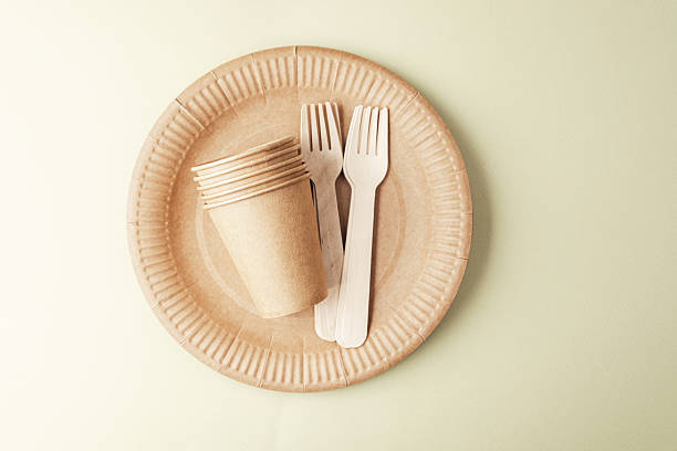 istock Eco friendly tableware arrangement on green background with paper cups and forks 2234572549