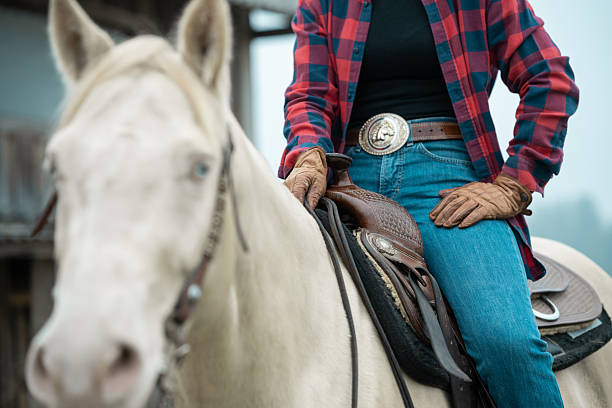 a young boy is trying to get his reins right to start riding