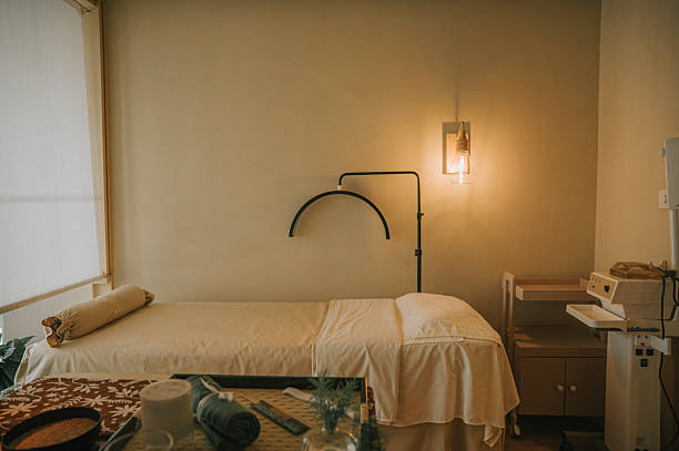 Serene spa treatment room prepared with a bed and soft lighting, creating a peaceful and welcoming atmosphere for relaxation and wellness Bangkok