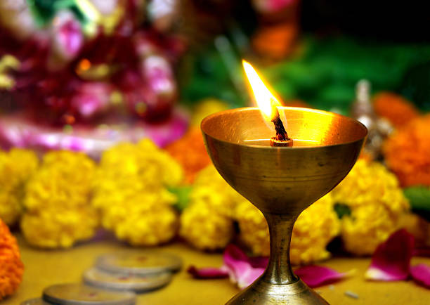 istock Burning Brass Diya with Flowers in Background 2234581945