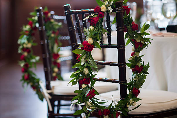 Wedding Chairs Decorated with Red and White Floral Garlands in Providence, Rhode Island, United States