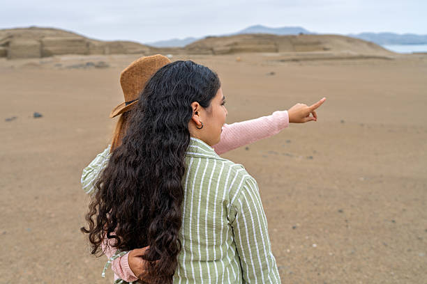 istock Tourists exploring ancient ruins in the desert 2234584761