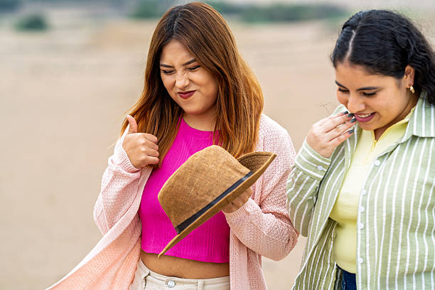 Two young women dressed like detectives.