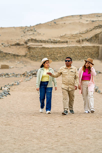 istock Tourists exploring pre-inca ruins in peruvian desert 2234584777