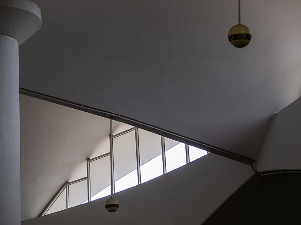 istock White interior ceiling of a building with round lamp lighting and glass fixed windows. 2234585865
