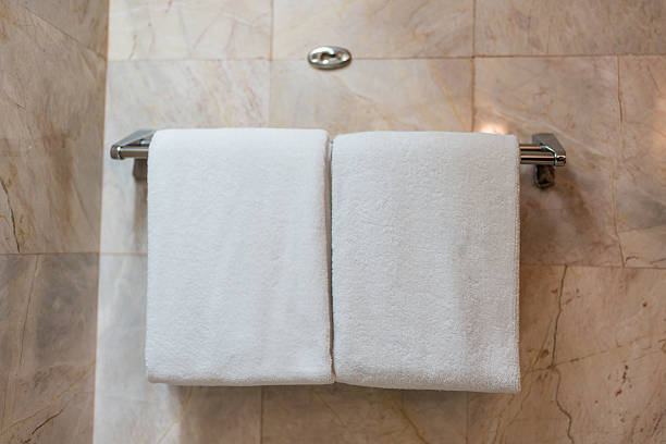istock White bathroom towels hanging on the rack 2234587846