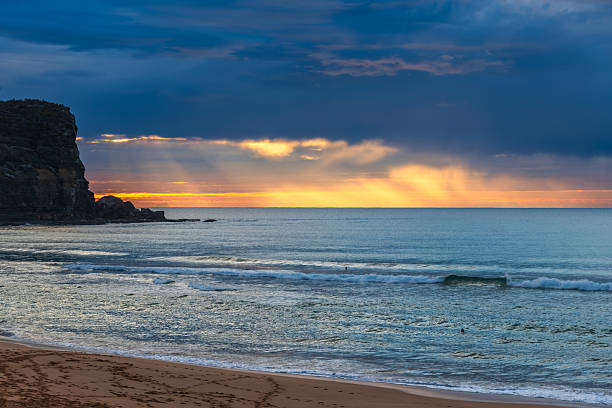 istock Winter sunrise by the sea shore with rain clouds 2234589465