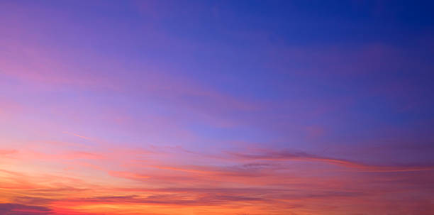 istock Twilight sky background with natural light and colorful orange sunlight cloud on blue evening sky in panoramic view 2234590174