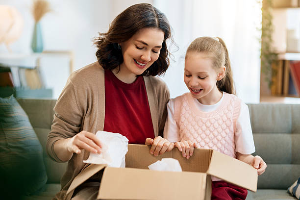 istock Mother and daughter are unpacking cardboard 2234593845