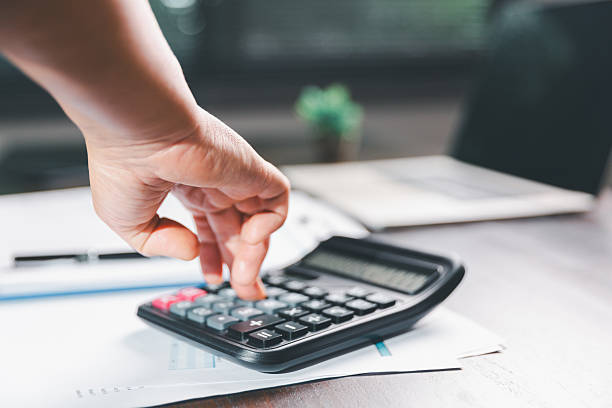 istock Office businesswoman hand to operate calculator analyzing financial data, counting costs on desk. accounting, financial analysis for business budget planning, calculation support, finance management. 2234597366