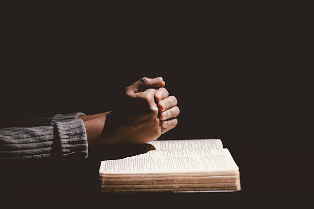 istock Hands folded in prayer on the Holy Bible, symbolizing faith, devotion, Christianity, hope, and spiritual strength. Concept of worship, meditation and trusting God Word. 2234597594