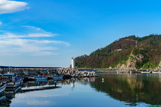 istock Blue sea view of the harbor with a white lighthouse 2234599498