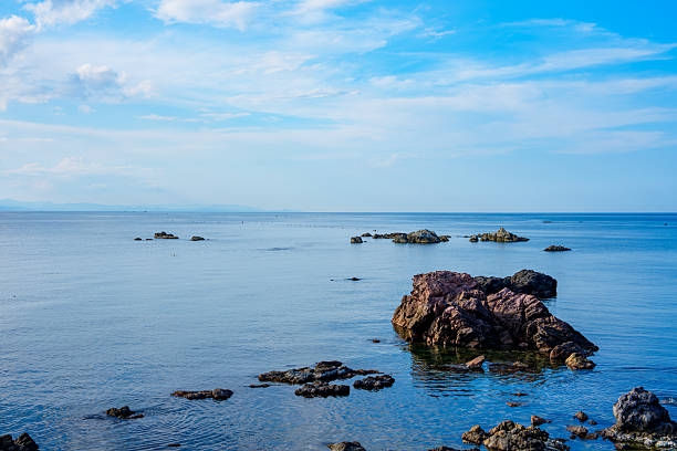 A blue seascape with scattered rocks