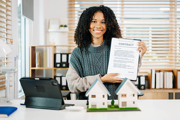 istock Young real estate agent worker working with laptop and tablet at table in office 2234599756