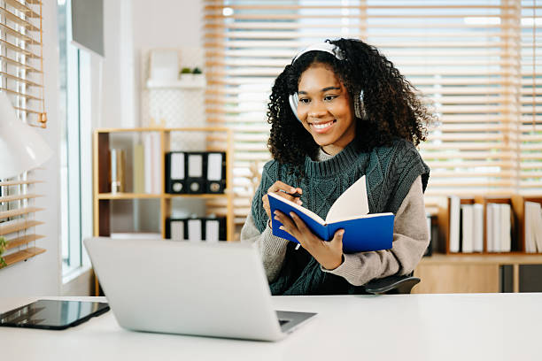 istock young student studying at the college library, sitting at the desk, using a laptop computer, tablet and headphones 2234599759