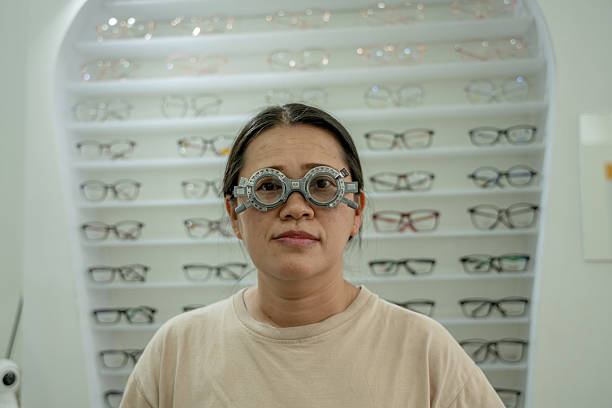 istock Woman in optometry clinic wearing a trial frame during an eye examination used for testing different lenses to determine prescription for eyeglasses of regular vision checkups and proper eye care. 2234601552