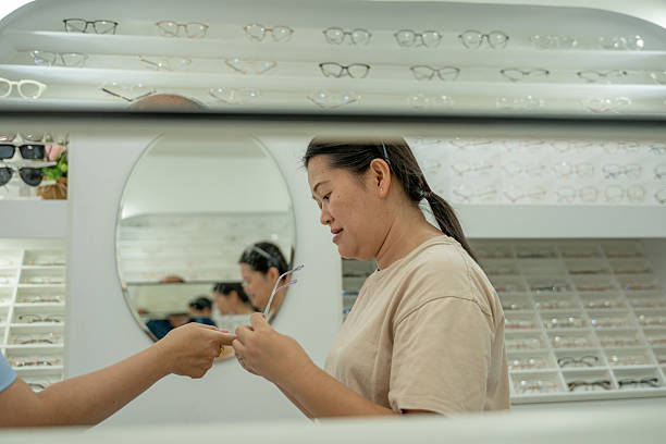 istock Woman browsing eyeglass frames optical store comparing different styles and shapes choosing new prescription or exploring fashionable eyewear options content related eye health or fashion 2234601554
