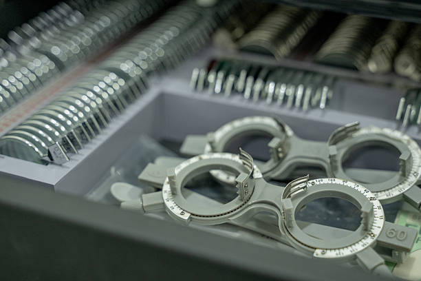 Close-up image optometry trial lens set and trial frames used for eye examination equipped with adjustable dials in the foreground, highlighting precision design for accurate refraction measurement.