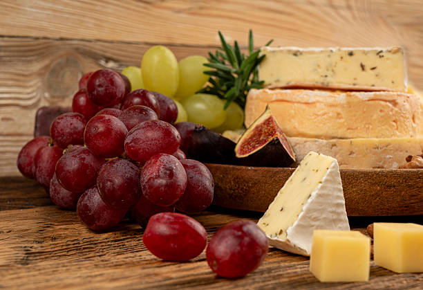istock Cheese plate of color cheeses variety, yellow, white and blue cheese board, assorted dairy products 2234603307