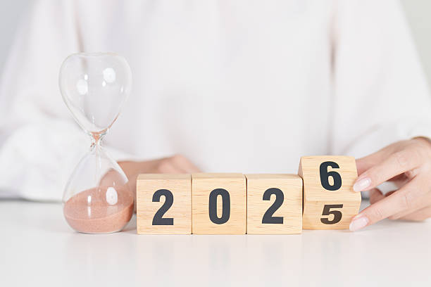 istock 2025 end year to Happy New Year 2026 with hourglass on table. Resolution, time, plan, goal, motivation, reboot, countdown and New Year holiday concepts 2234603495