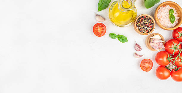 istock Fresh tomatoes, garlic, basil, olive oil, and spices on white background. Long banner format. top view. copy space 2234603637