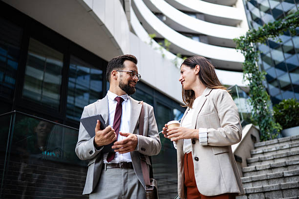 istock Business people talking and walking outside office building 2234606090