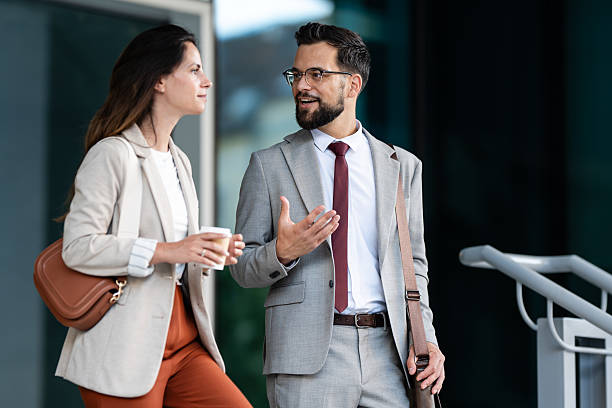 istock Businesspeople talking and walking outside office building 2234606356