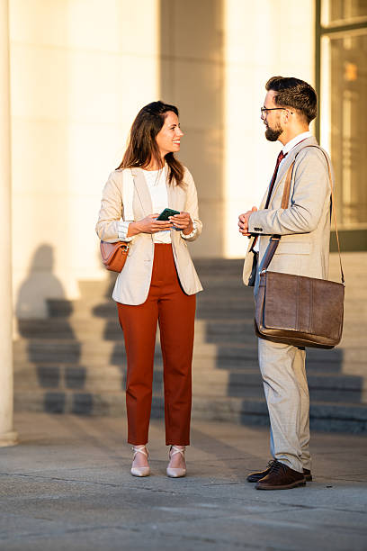 istock Businesspeople talking outside office building during coffee break 2234606459