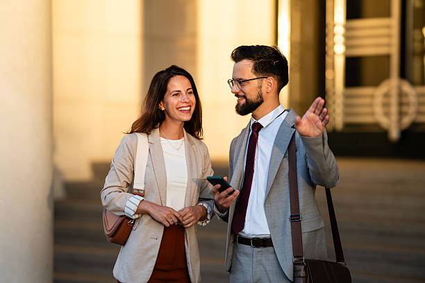 istock Businesspeople walking and talking outdoors, waving at someone 2234606468