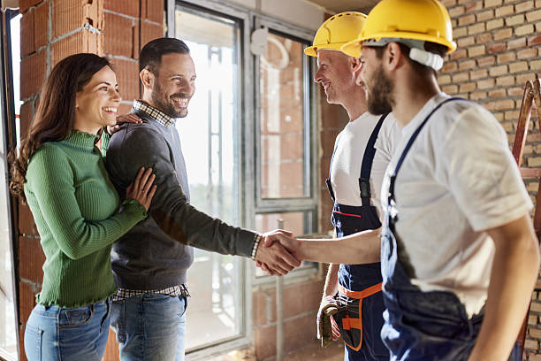 istock Happy manual workers came to an agreement with a couple at construction site. 2234606509