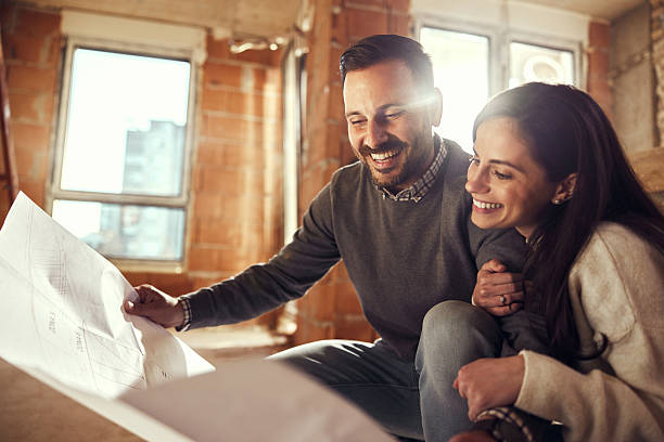 istock Happy couple analyzing plans at their renovating apartment. 2234606838
