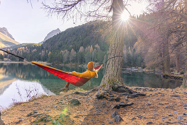 istock Woman Relaxing in Hammock by Mountain Lake 2234607359