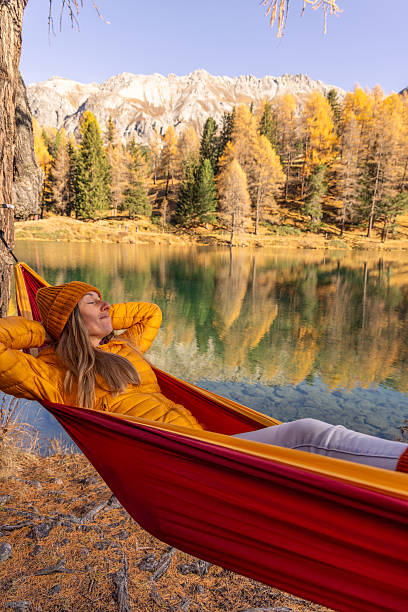 istock Woman Relaxing in Hammock by Mountain Lake 2234607398