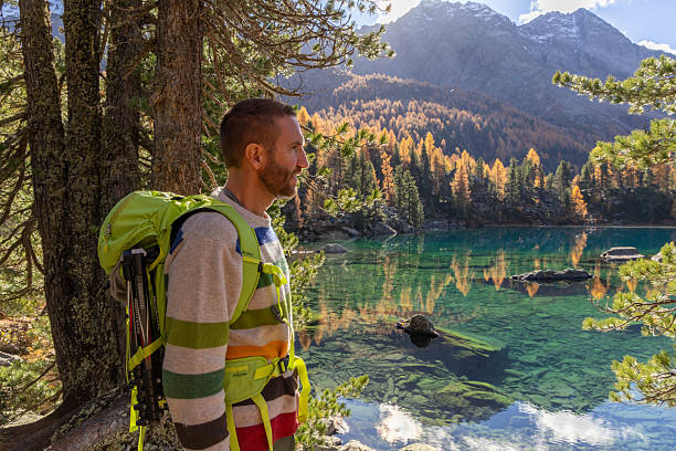 istock Man Hiking Near Clear Mountain Lake 2234609588