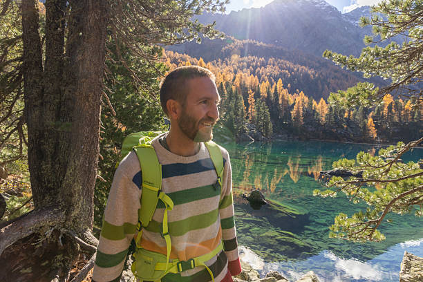 istock Man Hiking Near Clear Mountain Lake 2234609671