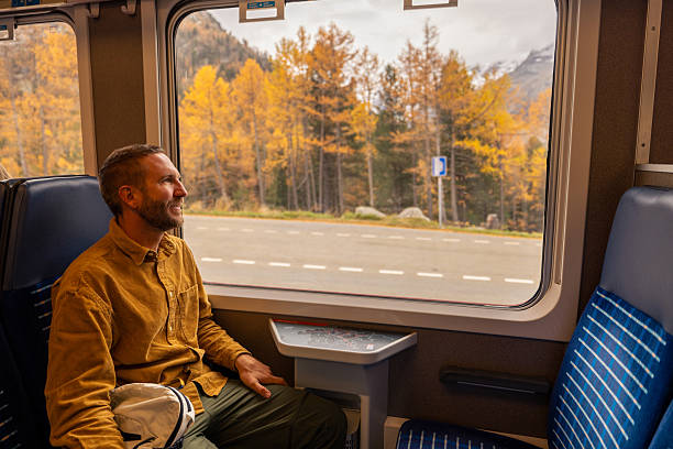istock Man Enjoying Autumn Train Ride View 2234610128