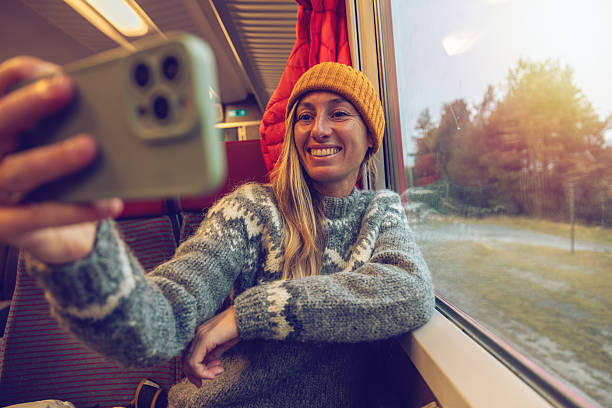istock Young Woman Taking Selfie on Scenic Train Ride 2234611800