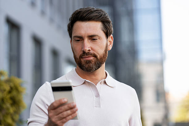 istock Businessman using smartphone in urban city setting 2234614253