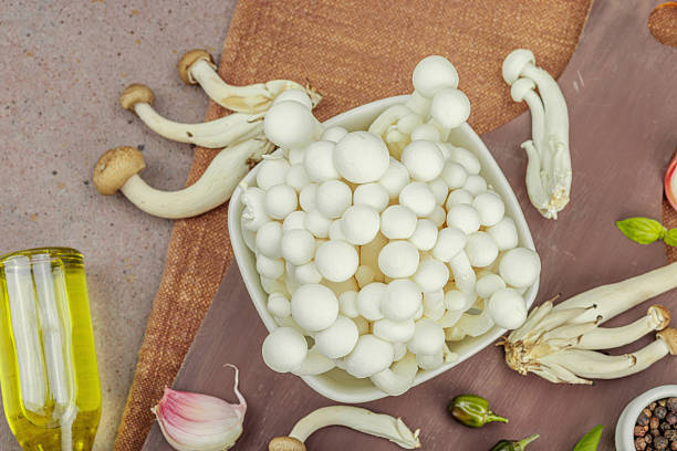 istock Fresh assorted shimeji mushrooms with olive oil, basil, garlic, salt, pepper on rustic background 2234614741
