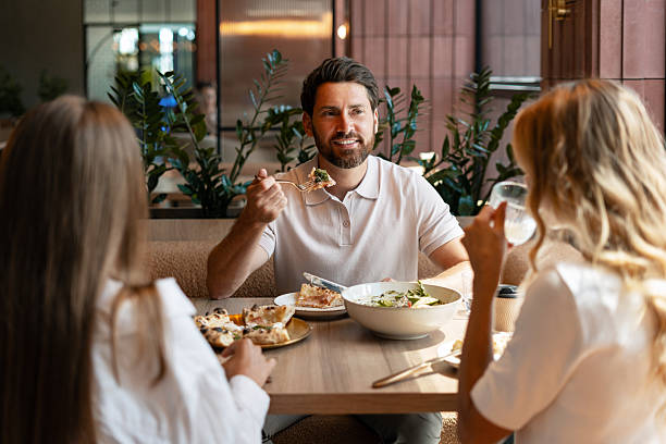 istock Friends enjoying lunch together at a restaurant 2234616027